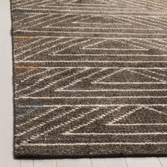 a brown rug with an abstract design on the top and bottom, sitting on a white floor