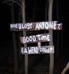 there are many street signs in the woods with words on them that read have lost anyone? good time 4 a men's court