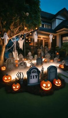 halloween decorations in front of a house with jack - o'- lanterns and tombstones