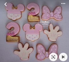 decorated cookies with pink and gold minnie mouses on them are shown in the shape of numbers