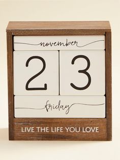 a wooden clock with the words november 23rd friday live the life you love