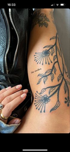 a woman's arm with tattoos on it and the words, love is in the air