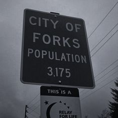 this is a street sign that says city of forks population 3 175 and it's in black and white