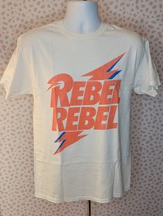 David Bowie Rebel Rebel Bolt Tee Bowie's iconic red and blue lightning bolt. Slightly distressed edges White Men's Size Tee A Goodie Two Sleeves officially licensed product. Bowie Lightning Bolt, Blue Lightning Bolt, Blue Lightning, Vintage Band Tees, Music Tees, Band T Shirts, Vintage Band, Lightning Bolt, Lady Bug