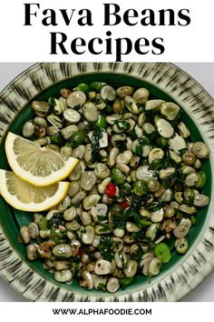 a green bowl filled with beans and lemon slices