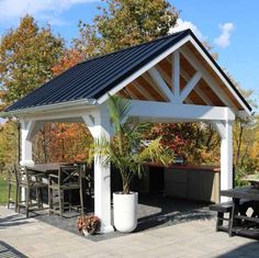 a gazebo with tables and chairs around it