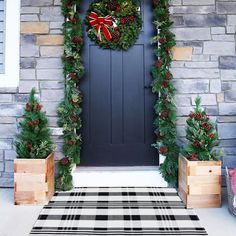 the front door is decorated for christmas with wreaths and pine cones