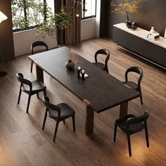 a dining room table with four chairs and a plant in the corner on top of it