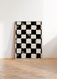 a black and white checkerboard pattern is on the wall in an empty room