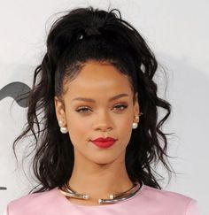 a close up of a person wearing a pink dress and red lipstick on her lips