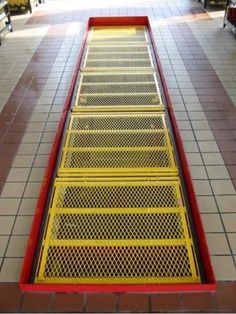 a red and yellow ramp in the middle of a floor