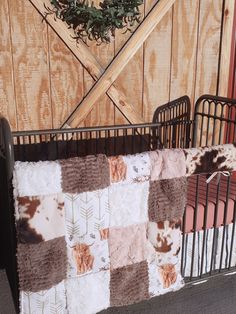 a baby crib with a brown and white blanket