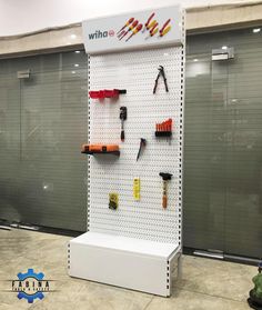 there is a display in the store with tools hanging on it's side wall