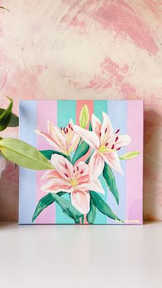 a painting of pink lilies on a blue and pink striped background with green leaves