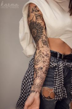 a woman's arm with flowers on it, and the top half of her sleeve