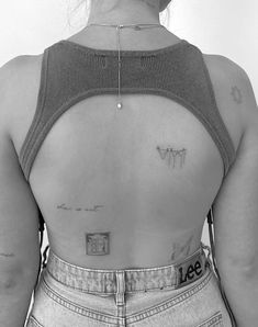 the back of a woman with tattoos on her chest