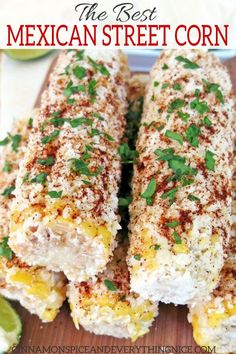 mexican street corn on a cutting board with cilantro, lime and parsley