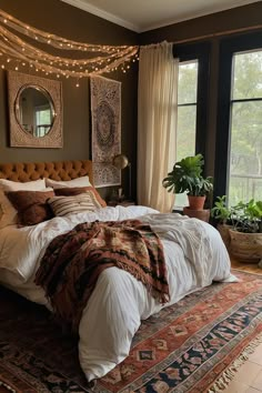 a large bed in a room with lots of lights on the ceiling and windows above it