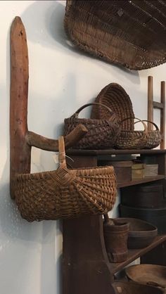 baskets and other items are hanging on the wall