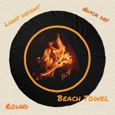 a round fire pit with the words beach towel written in orange and black on it