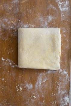 a piece of dough sitting on top of a wooden table