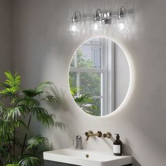 a bathroom sink under a round mirror next to a potted plant and large window