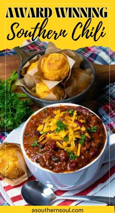 a bowl of chili with cheese and bread on the side, along with other food items