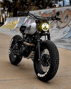 a motorcycle parked in front of a skate park