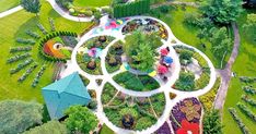 an aerial view of a garden with lots of trees and flowers in the middle of it