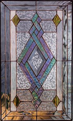 a stained glass window with an intricate design on the bottom and sides, in different colors