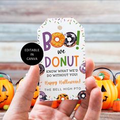 a hand holding up a halloween tag that says, boo we donut know what'd do without you happy halloween