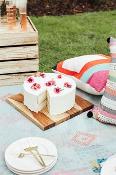 a cake sitting on top of a wooden cutting board