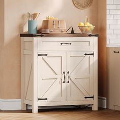 a white cabinet with doors and drawers in a kitchen next to a wall mounted clock