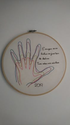 the embroidery is hanging on the wall and it has an embroidered hand that says congratulations to someone who was born in 2009