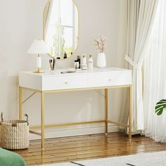 a white and gold dressing table with a mirror on it in front of a window