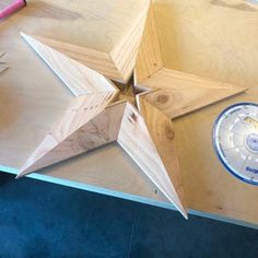 an unfinished wooden star on top of a table