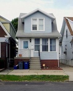 a blue house sitting on the side of a street