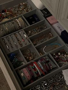 a drawer filled with lots of jewelry and bracelets