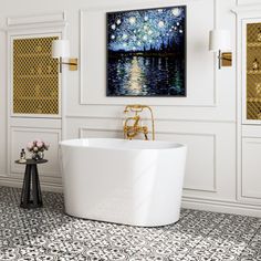 a white bath tub sitting in a bathroom next to a painting on the wall above it