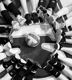 a group of people standing in a circle with their feet on top of each other