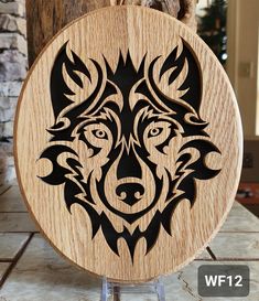 a wooden plaque with an image of a wolf's head on it, sitting on a table