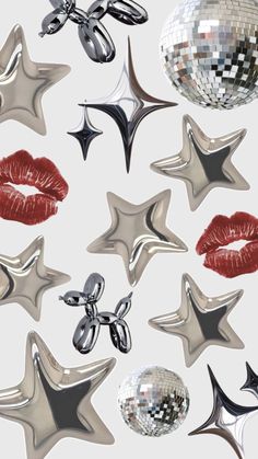 many shiny objects are arranged in the shape of stars and kiss - like shapes, with red lipstick on their lips