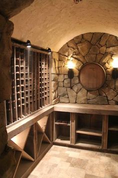 a wine cellar with stone walls and shelves