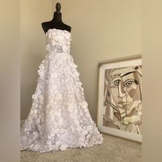 a dress is on display next to a painting