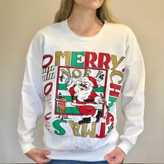 Vintage 80s/90s White Christmas Sweatshirt/Sweater Featuring A Thumbs Up Santa Painting "Noel" With Rudolph. "Merry Christmas" And "Ho Ho Ho" Are Also Boxed Around The Santa Graphic In Colors Of Red, Green, Black, White (Puff Paint), And Metallic/Sparkly Gold (Doesn't Shed Glitter). Ribbed Bottom Band And Crew Neck. Thinner Sweatshirt And Soft, Especially On The Inside. Good Vintage Condition-- New Old Stock With A Tag, But Does Have Some Minor Pilling From Age, A Tiny Spot On The Arm And Tiny P Retro White Winter Sweatshirt, Retro White Sweatshirt For Winter, White Retro Winter Sweatshirt, Retro White Sweater With Letter Print, White Retro Sweater With Letter Print, Retro Long Sleeve Christmas Sweater, Retro Crew Neck Tops For Winter, Vintage Christmas Crew Neck Top, Retro Crew Neck T-shirt For Winter