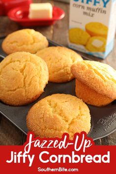 baked - up cornbread muffins on a baking tray next to a carton of milk