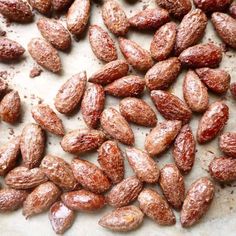 some almonds are sitting on a piece of parchment paper and ready to be eaten