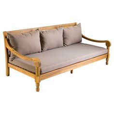 a wooden couch with four pillows on it's back and arm rests against a white background