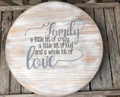 a wooden plaque with the words family, a little bit of crazy and a whole lot of love on it