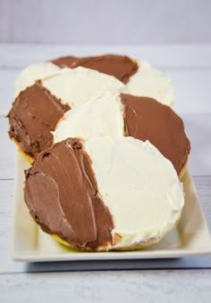 three pieces of chocolate cake on a plate with white frosting and one slice missing